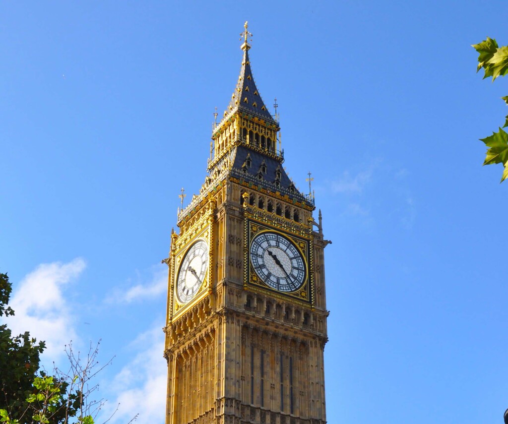 Ancient Big Ben clock tower in front of a cloudy sky